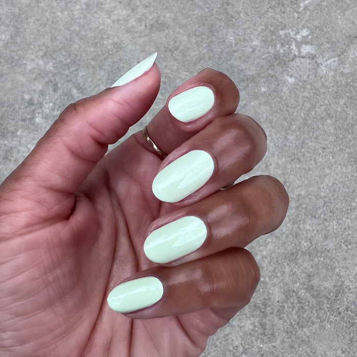 Corrigan mint pastel green polish on oval nails with a glossy finish for a smooth, quick dry at-home mani by Olive and June