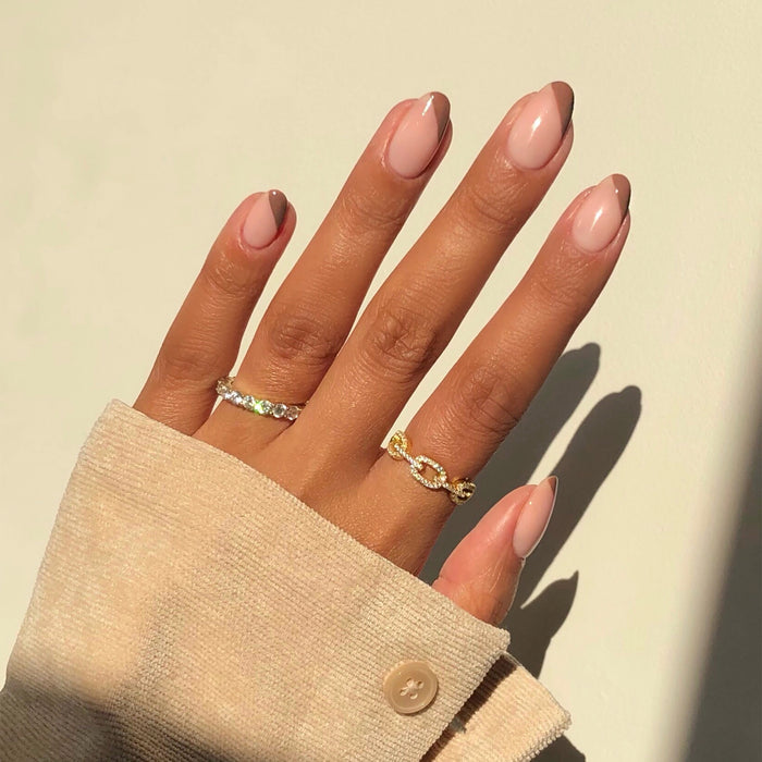 Cup O'Latte neutral brown nail polish manicure on a medium skin tone in sunlight
