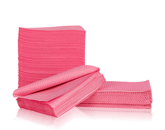 Stack of pink disposable bibs on a white background