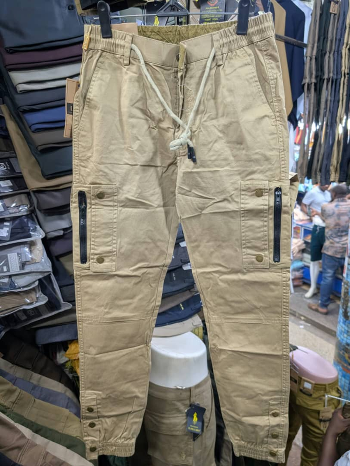 Men's khaki cargo pants with zippered pockets and white drawstring