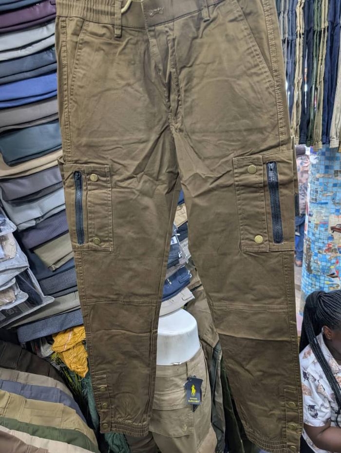 Men's olive brown cargo pants with zippered pockets and snap buttons