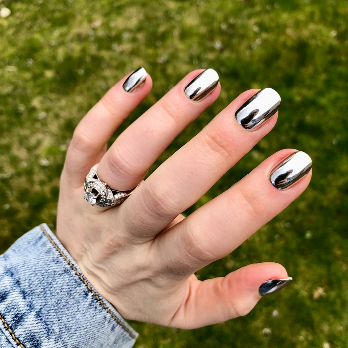 Mirror Chrome - Press-On | Extra Short | Round showing hand with shiny extra short round false nails in reflective chrome finish