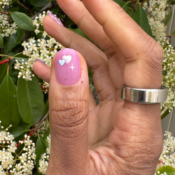 Puffy Hearts - Press-On | Short | Round showing hand with pink short round press-on nail featuring raised heart embellishments