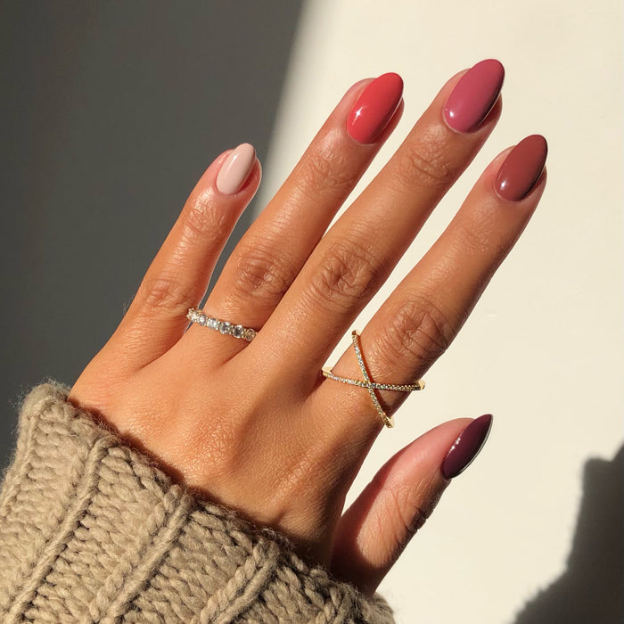 Time for a Bond-fire mauve nail polish manicure on a medium skin tone with rings