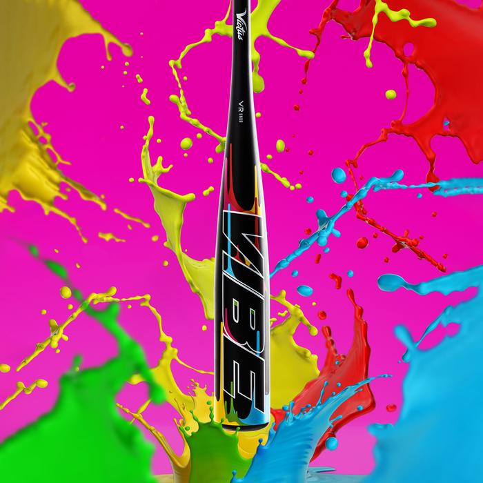 The 2024 Victus Vibe (-10) 2 3/4" USSSA Baseball Bat: VSBVIB10 stands upright against a vivid pink backdrop, splashed with bold colors, showcasing its one-piece aluminum construction and Victus’s vibration reducing knob.