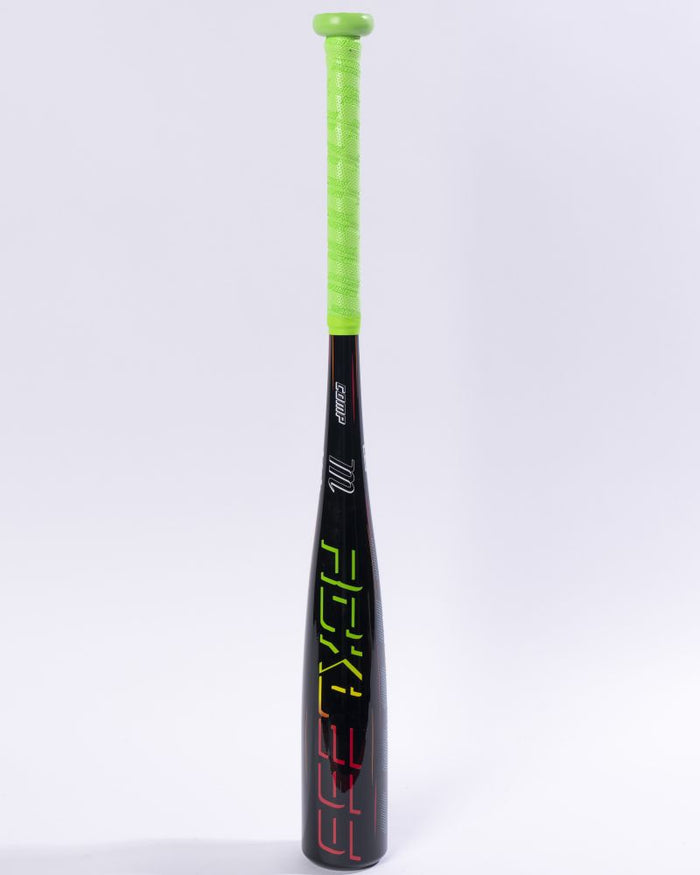 Standing upright against a plain white background is the Marucci 2027 RCKLESS Gen 2 Composite (-13) 2 5/8″ USA Tee Ball Baseball Bat (MTBRC2), a black, USA Baseball certified bat featuring a bright neon green grip and vibrant geometric patterns decorating the barrel.