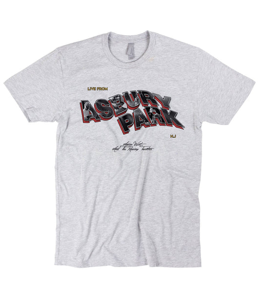 Grey t-shirt on a white background. Text reads "Live From Asbury Park" NJ. The Asbury Park portion is wavy 3D text. Aaron West And The Roaring Twenties in small centered black text below that.