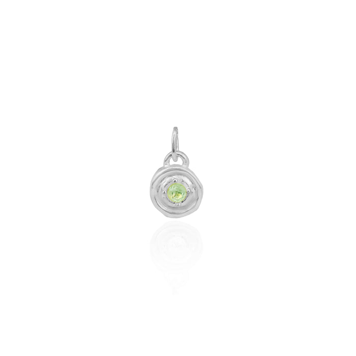 Silver pendant with a green gemstone on a white background