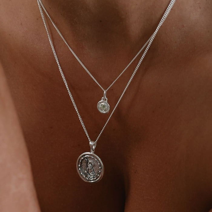 Sterling silver birthstone necklace layered with a delicate silver chain for an elegant everyday look