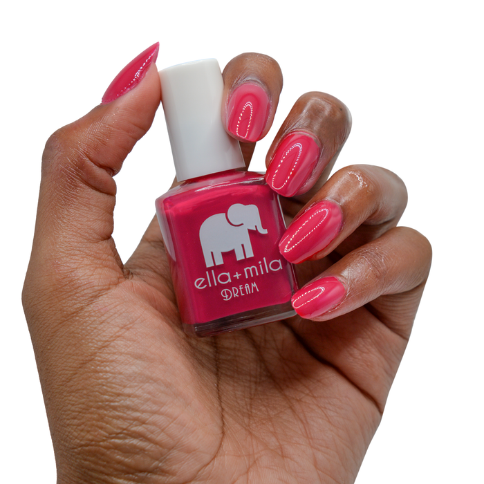 Bad Obsession raspberry red nail polish on a deep skin tone, hand holding the bottle