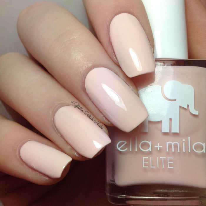 Barefoot pale nude pink nail polish close-up with the bottle