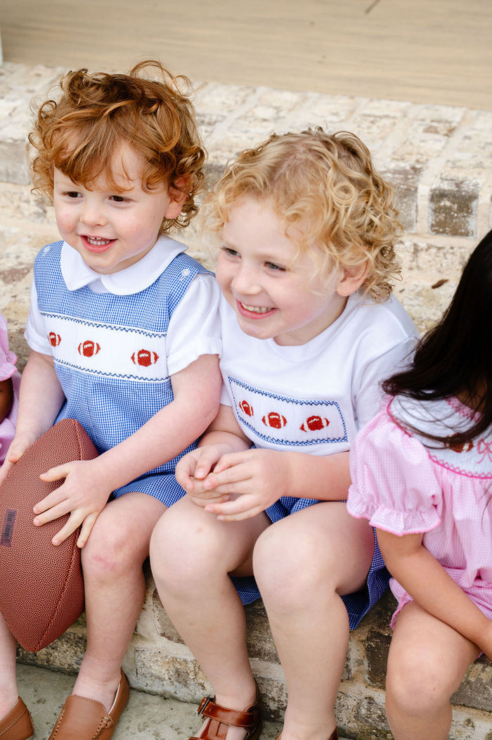 Boy's blue gingham game day jonjon featuring a hand-smocked football panel, a classic Southern look