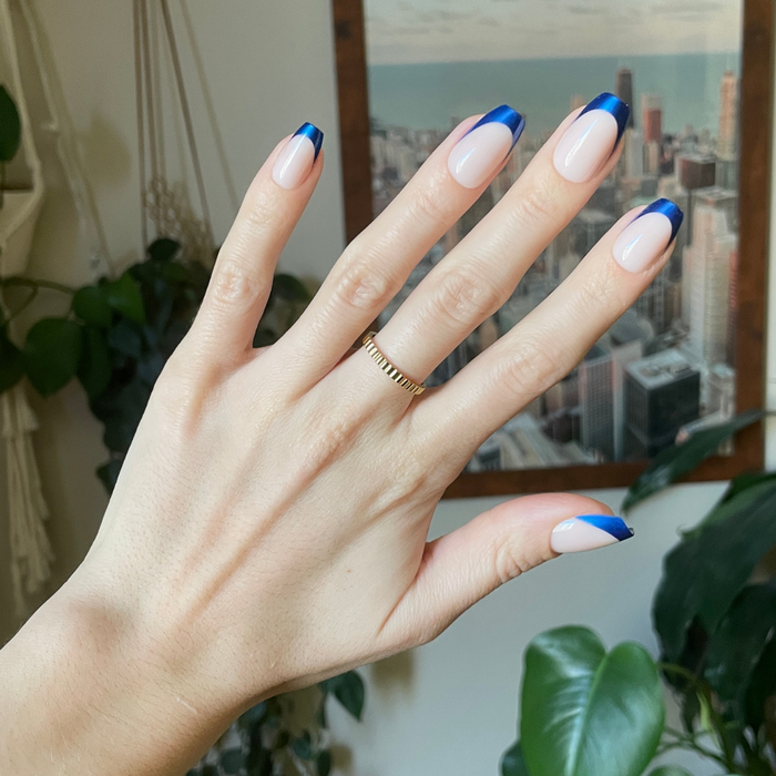 Blue Metallic French - Press-On | Medium | Coffin showing hand with medium coffin false nails featuring metallic blue french tips indoors