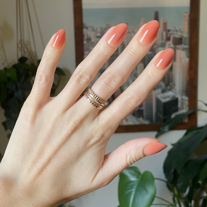 Caramel Syrup Gradient - Press-On | Medium | Oval showing hand with medium oval caramel gradient press-on nails indoors