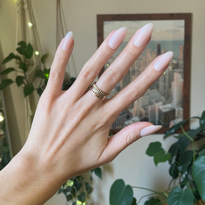 CCT Bridal Edition - Press-On | Long | Almond showing sheer pink long almond shaped press-on nails on hand with gold rings