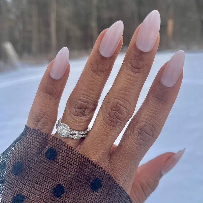 CCT Bridal Edition - Press-On | Long | Almond showing sheer pink long almond shaped nails on hand with diamond ring