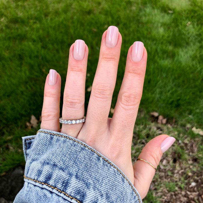 CDJ Syrup Gradient - Press-On | Short | Squoval showing hand with short squoval nails in neutral grey-beige polish outdoors