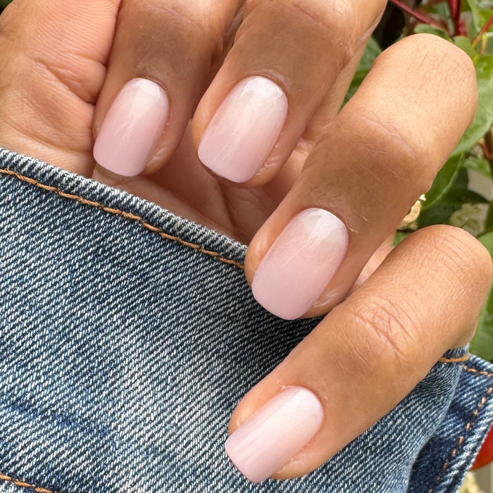 CDJ Syrup Gradient - Press-On | Short | Squoval showing hand with short squoval nails in soft neutral gradient manicure outdoors