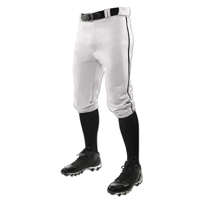 A person wears Champro Sports Champro Adult Triple Crown Knicker Baseball Pants with Piping: BP101A, paired with a black belt, black socks, and black cleats; only the lower body is shown against a white background.