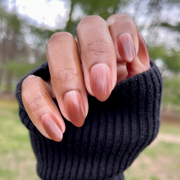 Chocolate Syrup Gradient - Press-On | Medium | Almond showing hand with cool-toned chocolate gradient press-on manicure outdoors