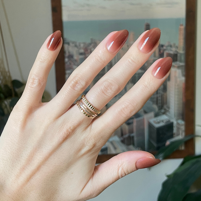 Chocolate Syrup Gradient - Press-On | Medium | Almond showing hand with medium almond cool chocolate gradient press-on manicure indoors