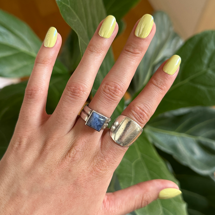 Citrus Chrome - Press-On | Short | Round showing hand with bright yellow shimmery chrome short round press-on manicure outdoors