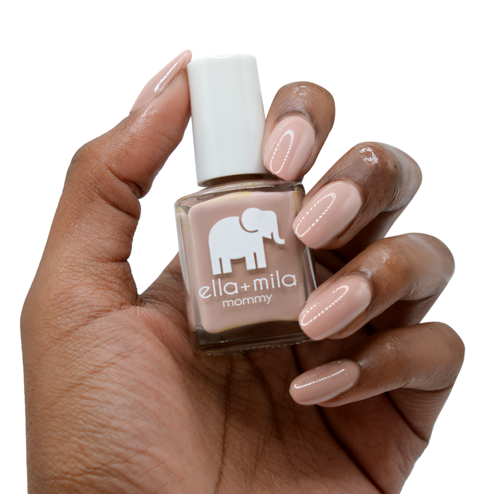 Cup O'Latte neutral brown nail polish on a deep skin tone, hand holding the bottle