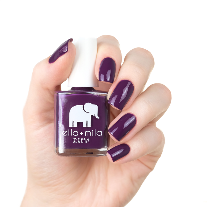 Date Night dark plum nail polish manicure on a light skin tone with the bottle