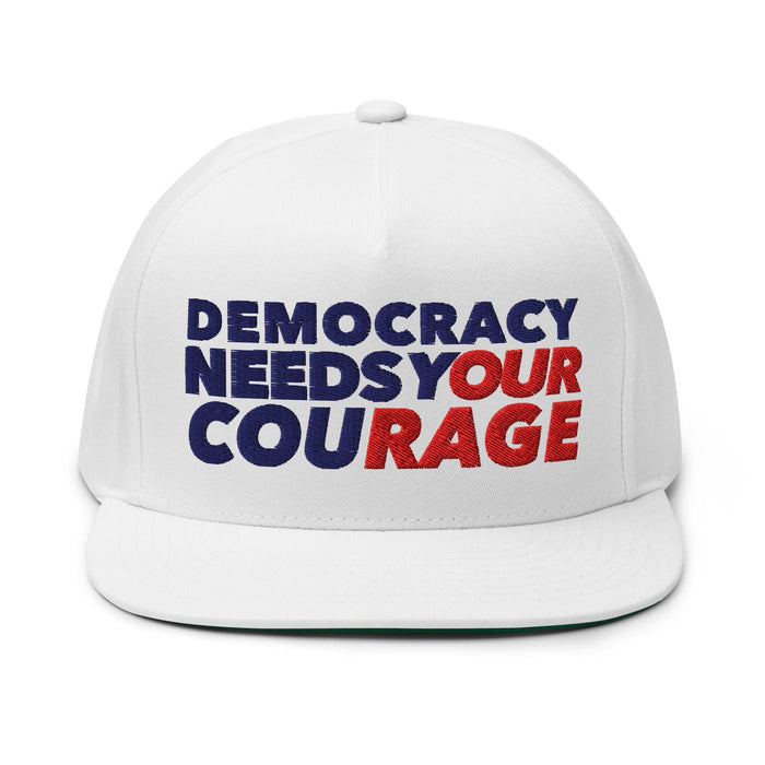 White cap with 'Democracy Needs Your Courage' text in blue and red on a white background