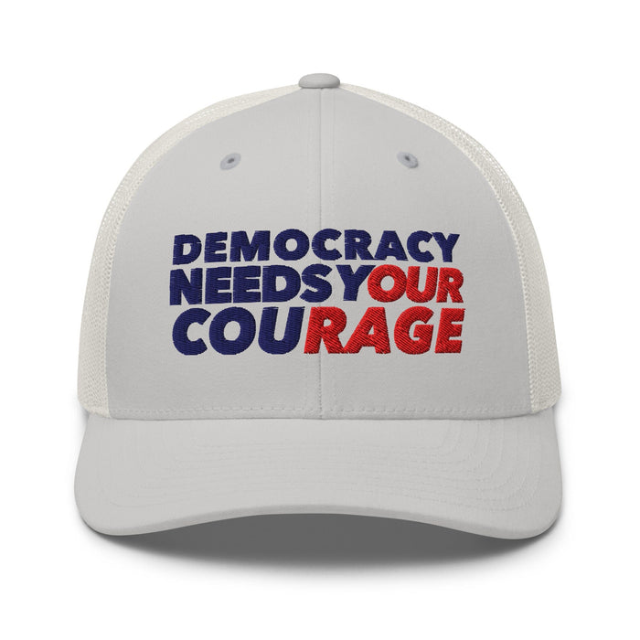 Silver cap with 'Democracy Needs Your Courage' text in blue and red on a white background