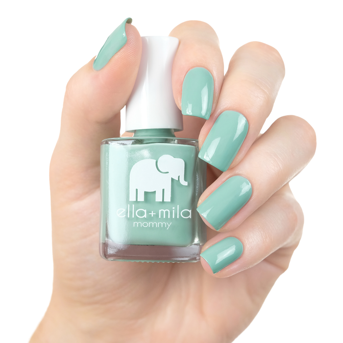 Don't Be Blue turquoise nail polish manicure on a light skin tone with the bottle
