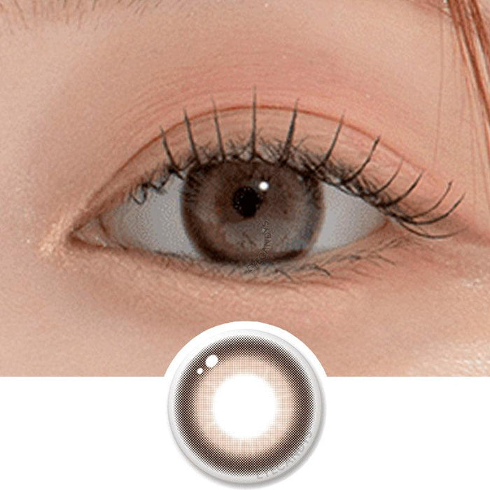Macro shot of an eye wearing the DooNoon Bono Cheese Grey prescription colour contact lens, showing the multi-colored detail and natural effect on dark brown eyes, with clean eye makeup. At the bottom is the pattern of the colored lens design, showing the dotted detail and pigmentation.