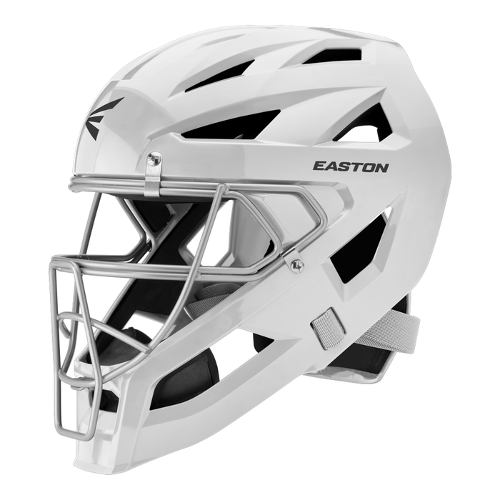 A white Easton Phenom Catcher’s Helmet (model PHENOMCH) by Easton, featuring a metal faceguard, side ventilation slots, and a chin strap—an essential piece of catcher’s gear—is displayed from a side angle against a white background.