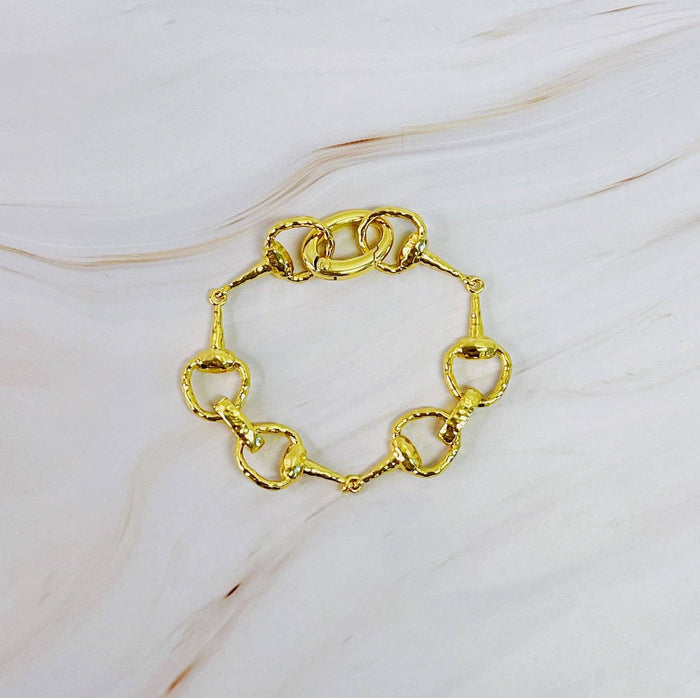 Ellison+Young equestrian linked bracelet featuring metal chain links and detailed horse-themed charms on a neutral background.
