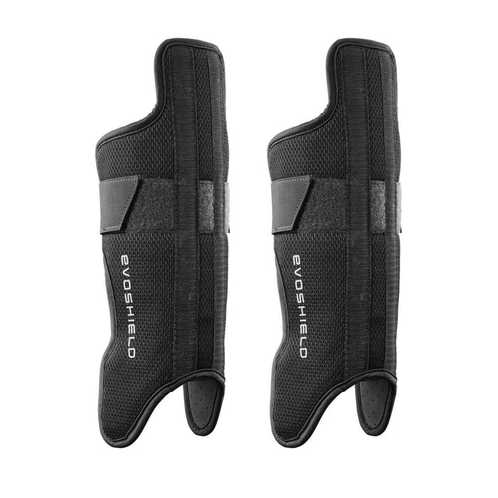 Two black EvoShield wrist guards with thumb holes and white logo, featuring a textured surface and wide strap. Pair them with EvoShield Pro-SRZ Gel-to-Shell™ Catcher's Lower Leg Guards (WB570800 / WB571030) for full custom catcher’s leg protection.