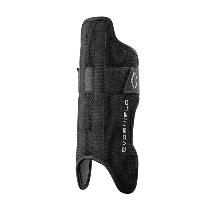 The EvoShield Pro-SRZ Gel-to-Shell™ Catcher's Lower Leg Guards (WB570800 / WB571030) feature a black, textured design with Velcro straps and thumb opening, offering custom-molded protection for the wrist and forearm.
