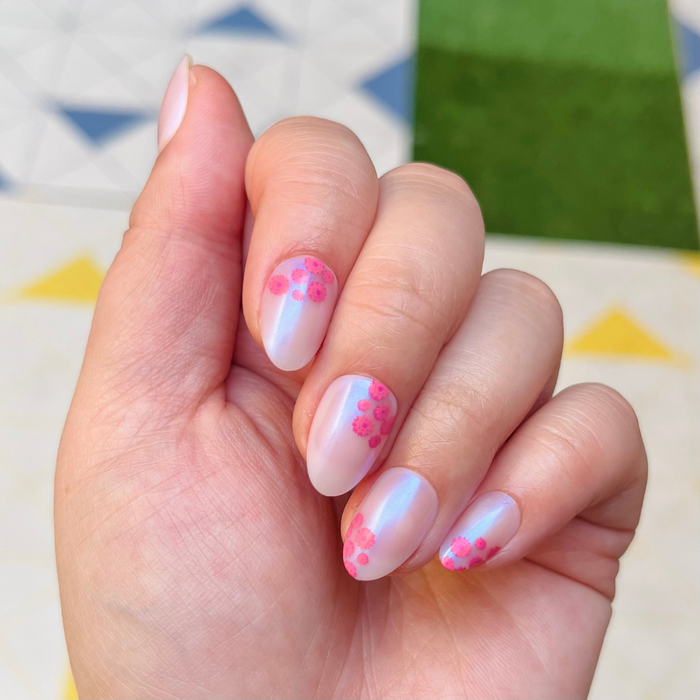 Fuchsia Florals - Press-On | Short | Almond showing hand with short almond iridescent nails and abstract fuchsia flower accents