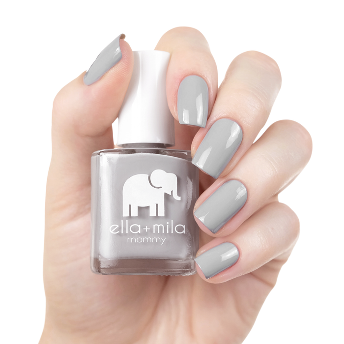 Grey Skies cement grey nail polish manicure on a light skin tone with the bottle