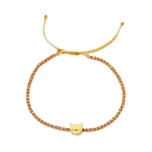 Gold-tone beaded bracelet with small cat charm centerpiece
