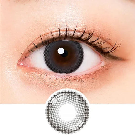 Macro shot of an eye wearing the i-Sha Oriana Mune Grey prescription colour contact lens, showing the multi-colored detail and natural effect on dark brown eyes, with clean eye makeup. At the bottom is the pattern of the colored lens design, showing the dotted detail and pigmentation.
