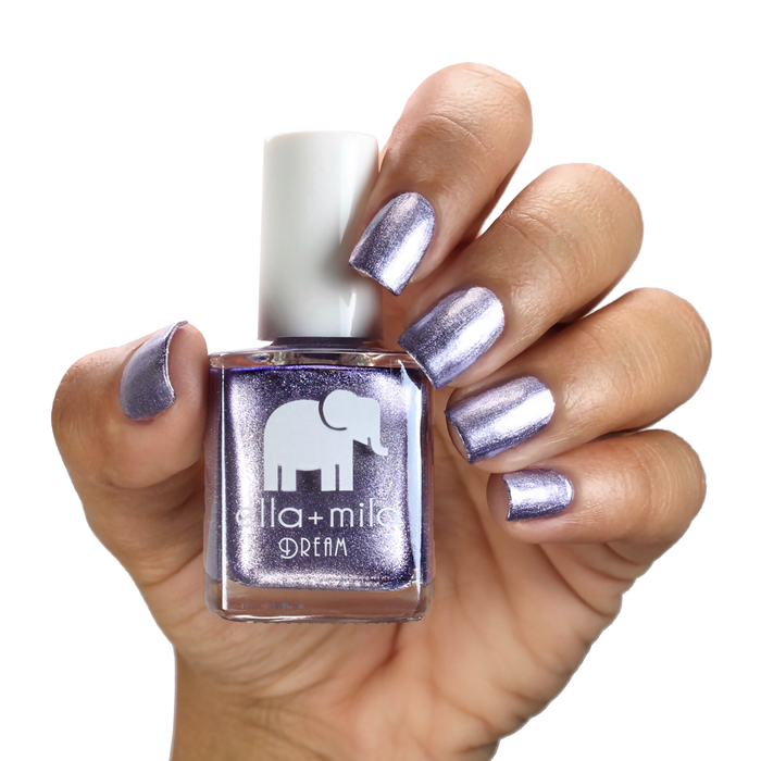 Icy Attitude metallic purple shimmer nail polish on a medium skin tone, hand holding the bottle
