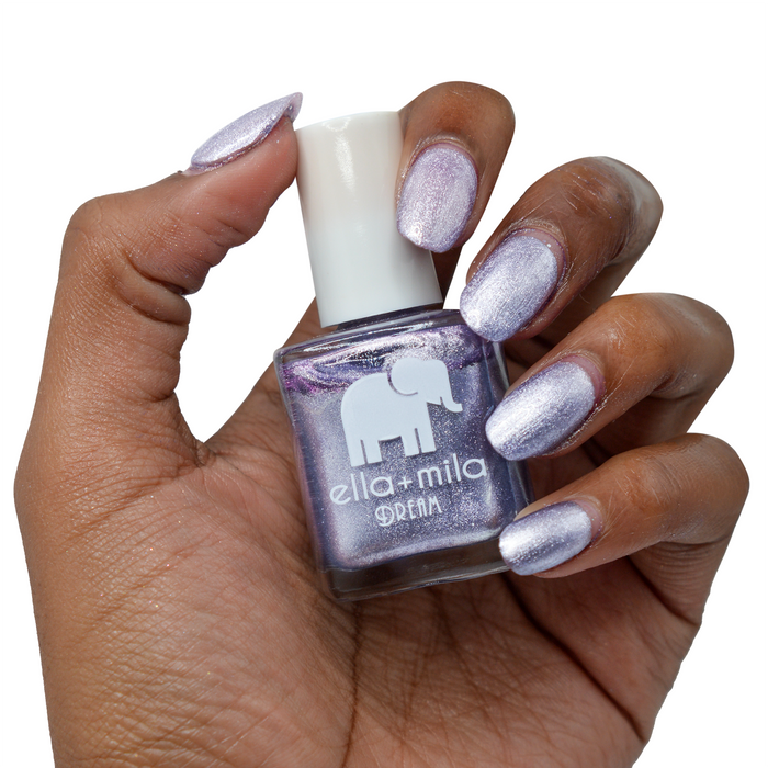 Icy Attitude purple metallic nail polish on a deep skin tone, hand holding the bottle