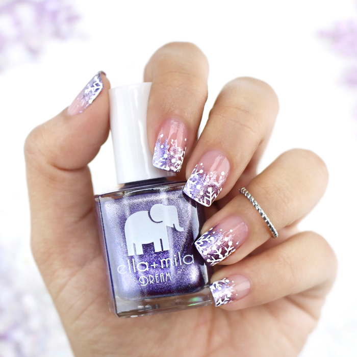 Icy Attitude metallic purple nail polish with white lace accent nails, holding the bottle
