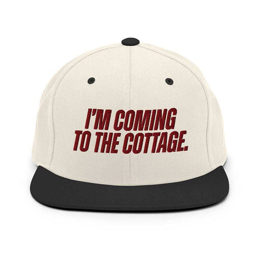 Beige cap with red text 'I'm Coming to the Cottage' on a white background