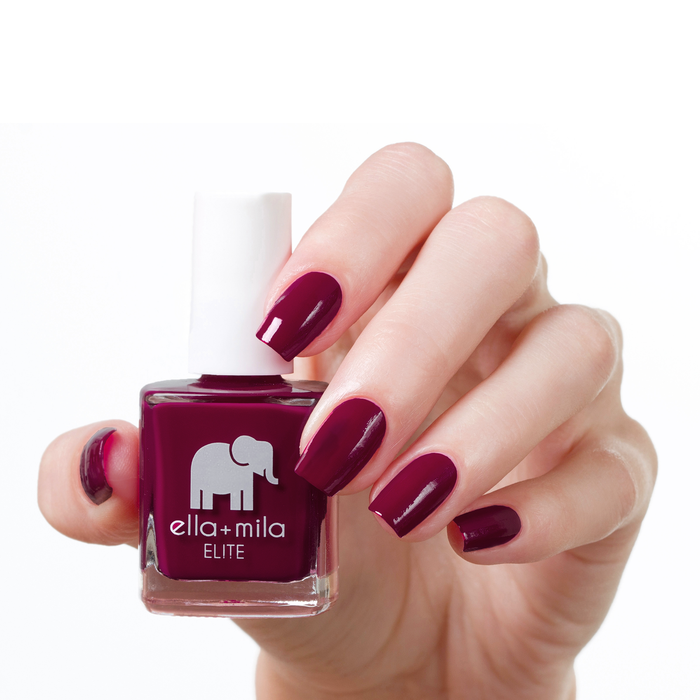 In Line for Wine wine red nail polish manicure on a light skin tone with the bottle