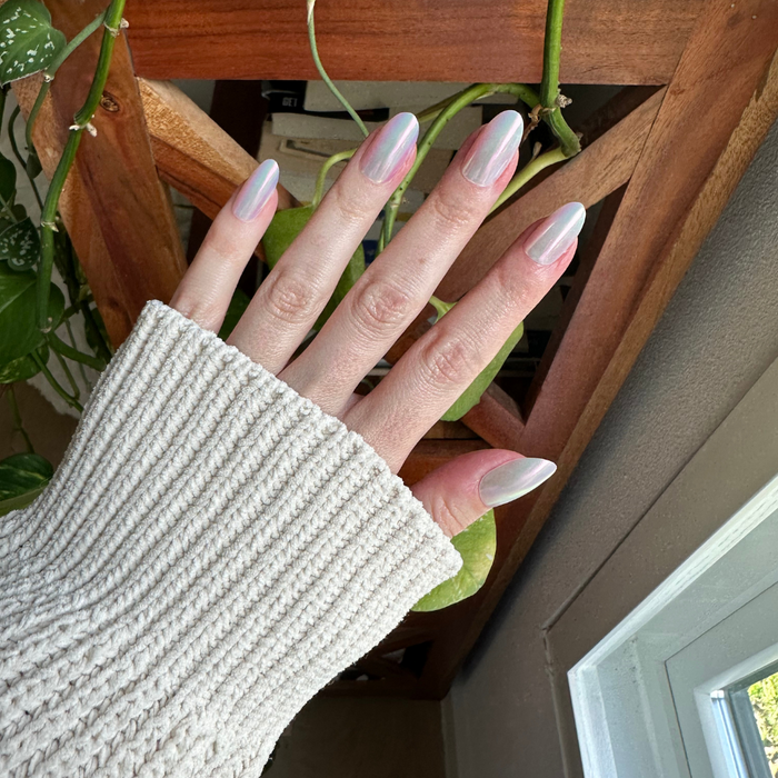Iridescent Shimmer - Press-On | Medium | Oval showing hand with medium oval iridescent shimmer false nails in natural light