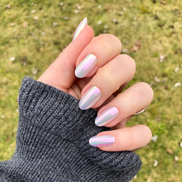 Iridescent Shimmer - Press-On | Medium | Oval showing hand with medium oval false nails in soft iridescent finish outdoors