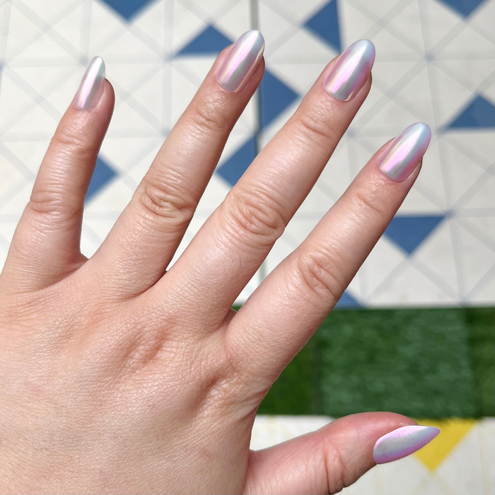 Iridescent Shimmer - Press-On | Medium | Oval showing hand with medium oval false nails in shimmering iridescent finish outdoors