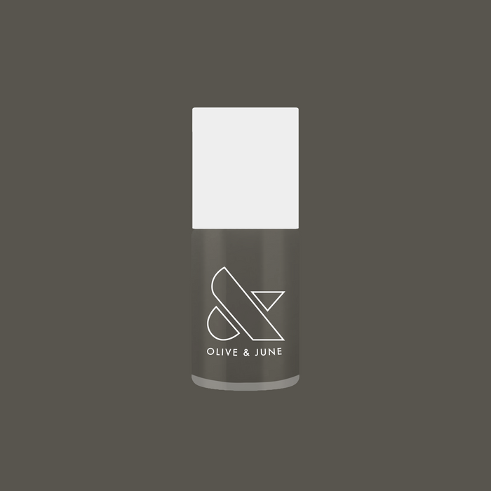 Olive and June nail polish bottle in deep charcoal gray shade Is it Smoky in Here? on matching gray background