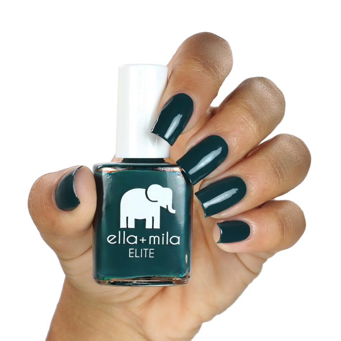Island Hopping dark green nail polish on a medium skin tone, hand holding the bottle